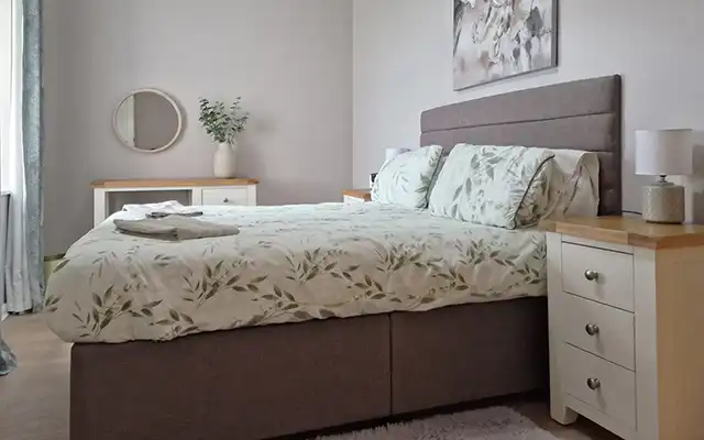 One of the bedrooms inside Sunrise Cottage at Bron-Y-Wendon Holiday Park